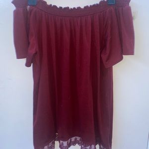 Off the shoulder maroon shirt.